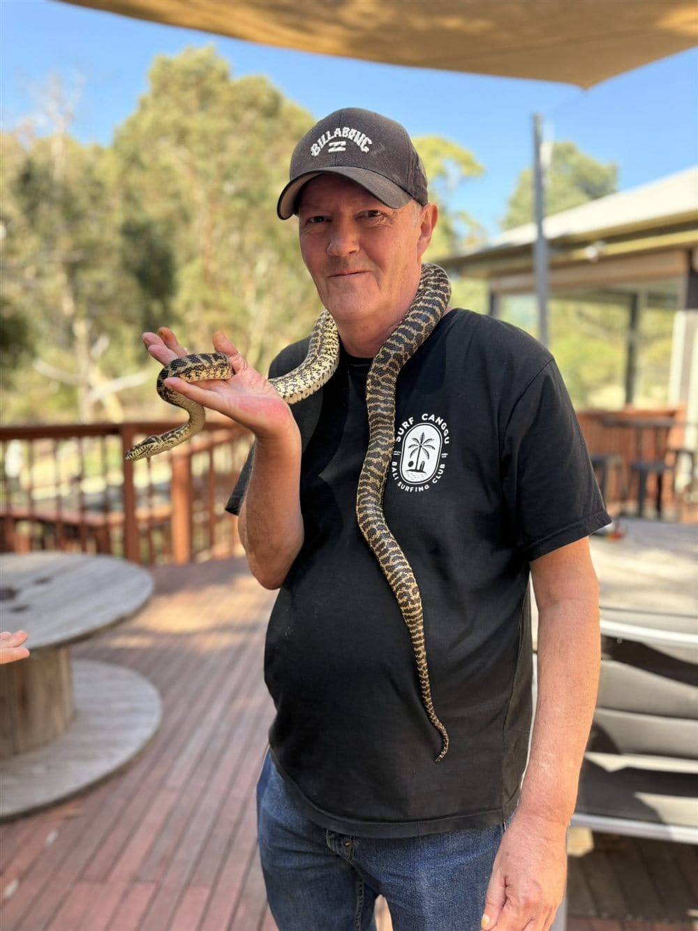 A participant holding a python around his neck at a wildlife encounter